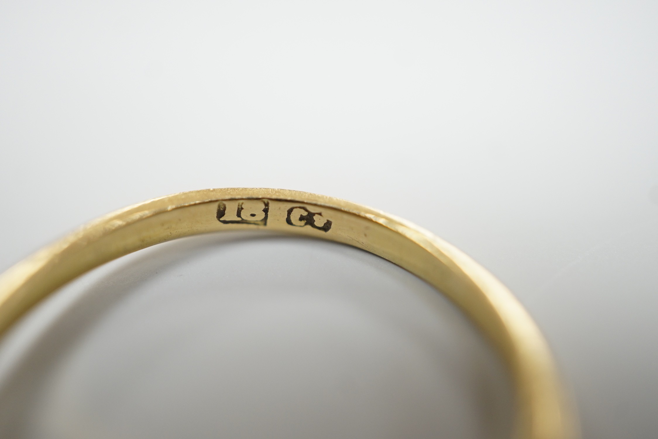 An 18ct, three stone peridot and two stone diamond set half hoop ring. size N, gross weight 2.6 grams.